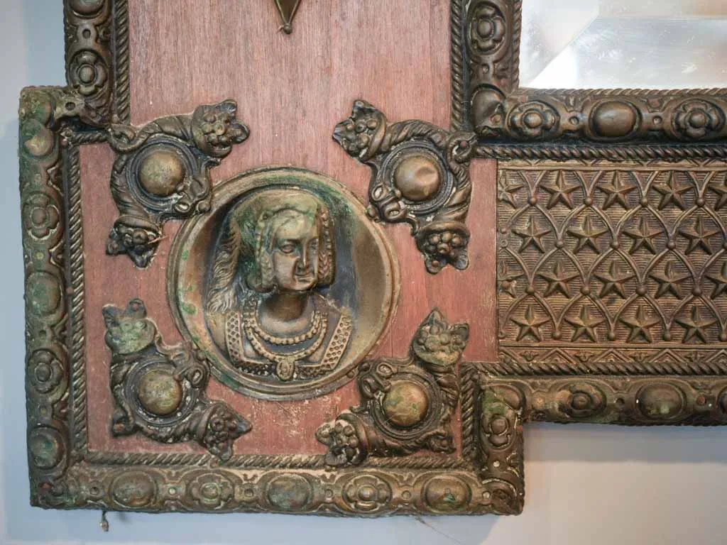 Curious large copper and wood mirror w/ medieval armor motifs